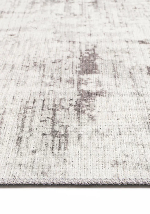 Elevate your home decor with the Abstract Evalina Grey Runner. Subtle distressed design in grey, made from recycled cotton. Stain and water-resistant with NanoWipe technology, machine washable, and anti-allergen for easy cleaning and care.